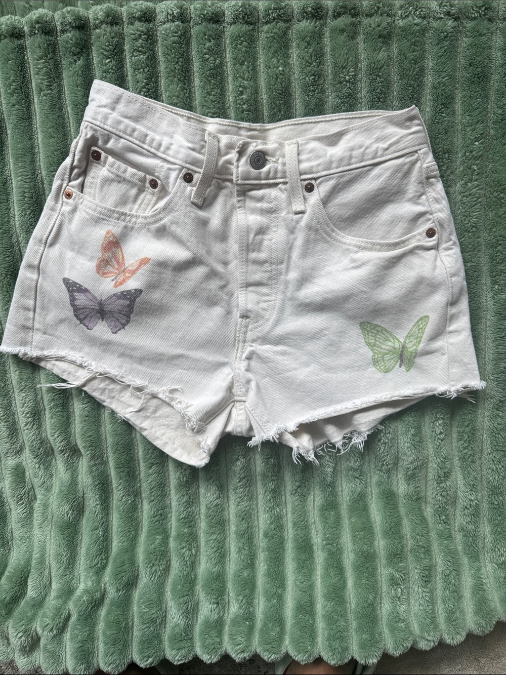 Levi's white/ cream  Denim Shorts with Pastel Butterfly Accents.